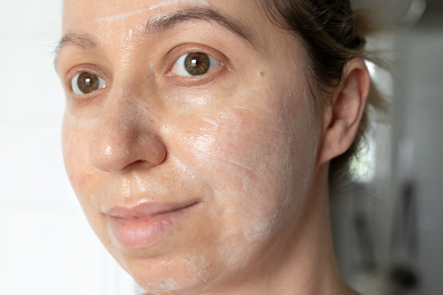 Person applying Clarins Cryo Flash Cream Mask evenly on their face, enjoying a refreshing skincare routine.